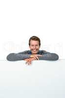 Smiling man on table against white background