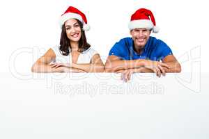 Man and woman wearing Santa hat