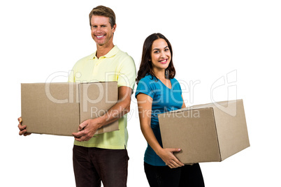 Couple holding boxes against white background