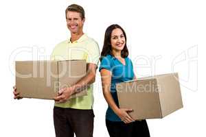 Couple holding boxes against white background