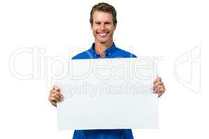 Smiling man holding board