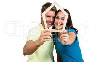 Portrait of happy couple holding frame
