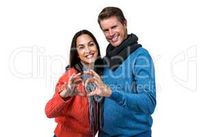 Portrait of couple making heart shape with hands