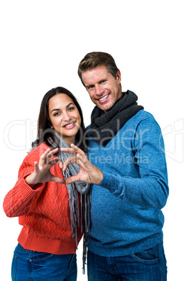 Smiling couple making heart shape with hands