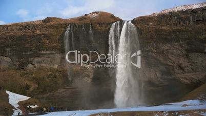 Time lapse of tourists at the waterfall Seljalandsfoss in Iceland