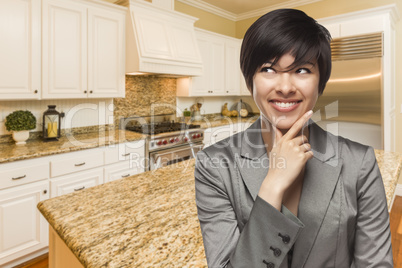 Mixed Race Woman Looking Back Over Shoulder Inside Custom Kitche