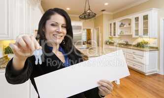 Hispanic Woman In Kitchen Holding House Keys and Blank Sign