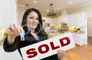 Hispanic Woman In Kitchen Holding House Keys and Sold Sign