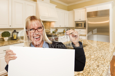 Young Woman Holding Blank Sign and Keys Inside Kitchen