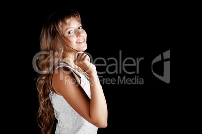 Smiling blue-eyed blonde girl in white dress on black background