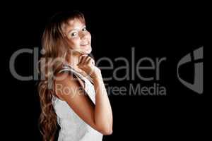 Smiling blue-eyed blonde girl in white dress on black background