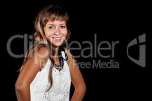 Smiling blue-eyed blonde girl in white dress on black background