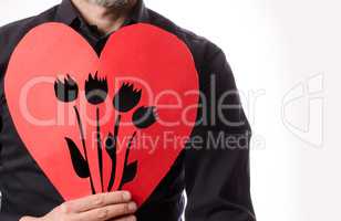 Man with a red paper heart shape