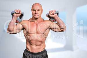 Composite image of portrait of muscular man lifting kettlebells