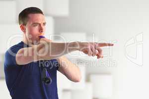 Composite image of trainer blowing whistle
