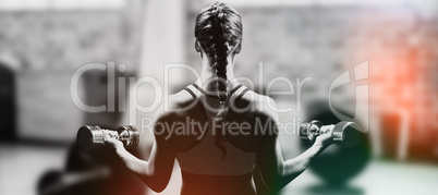 Composite image of rear view of braided hair woman lifting dumbb