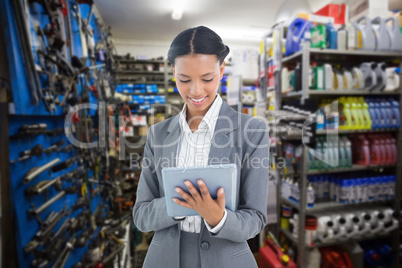 Composite image of businesswoman using a tablet with colleagues