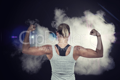 Composite image of rear view of muscular woman flexing muscles