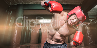 Composite image of aggressive boxer against black background