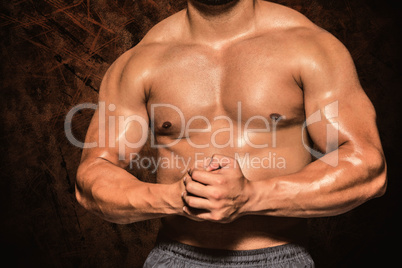 Composite image of mid section of a shirtless muscular man