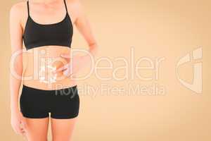 Composite image of closeup mid section of a fit woman with hand