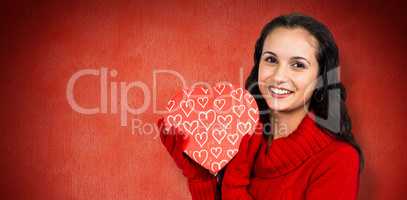 Composite image of smiling woman holding gift box