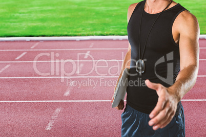 Composite image of personal trainer giving handshake