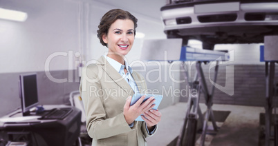 Composite image of smiling businesswoman holding digital tablet