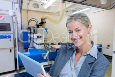 Composite image of portrait of smiling businesswoman using digit