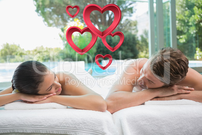 Composite image of couple lying on massage table at spa center