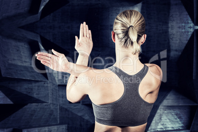 Composite image of muscular woman with arms crossed