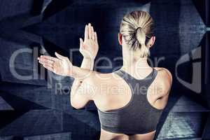 Composite image of muscular woman with arms crossed