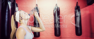 Composite image of sporty blonde drinking water