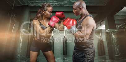 Composite image of male and female boxer with fighting stance