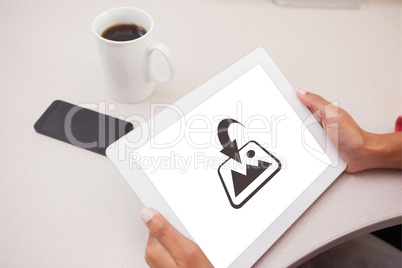 Composite image of woman using tablet pc