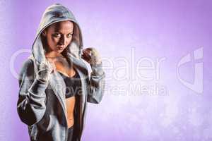 Composite image of portrait of female boxer in hood with fightin