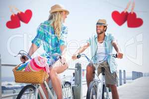 Composite image of couple on bike ride by the beach