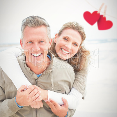 Composite image of smiling couple holding one another