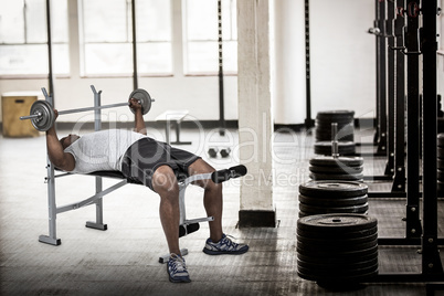 Composite image of fit man exercising with barbell