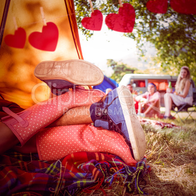 Composite image of young couple making out in tent