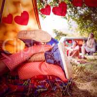 Composite image of young couple making out in tent