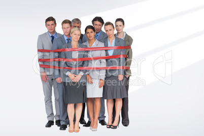 Composite image of upset business team fastened with adhesive ta