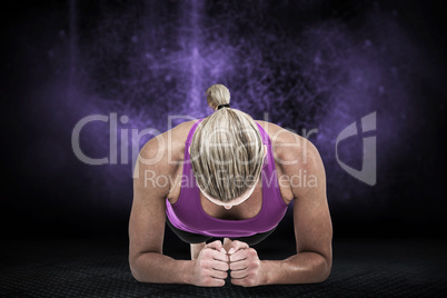 Composite image of muscular woman doing push ups