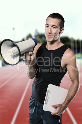 Composite image of trainer using megaphone while holding clipboa