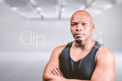 Composite image of portrait of bald bodybuilder with arms crosse