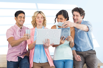 Composite image of casual businesspeople using digital tablet wi