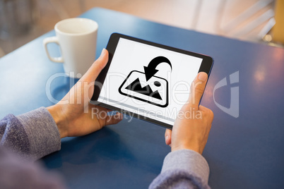 Composite image of man using tablet pc