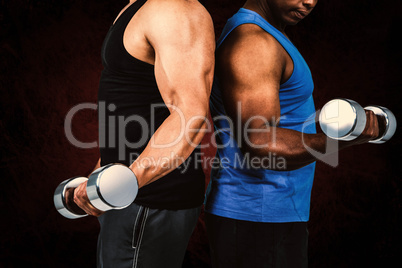 Composite image of strong friends posing with dumbbells