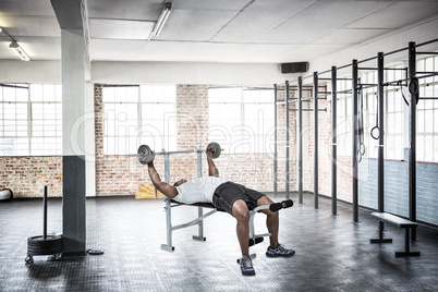 Composite image of fit man exercising with barbell