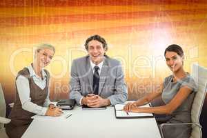 Composite image of portrait of smiling business people sitting a